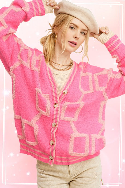 Introducing the Reina Cardigan, your go-to piece for effortless style. This slouchy and slightly oversized knit cardigan offers the perfect blend of comfort and fashion. With its drop shoulders design and soft, cozy fabrication, it's the ultimate throw-on-and-go essential. Embrace an easy and relaxed look while staying chic and comfortable with the Reina Cardigan.  pink barbie
