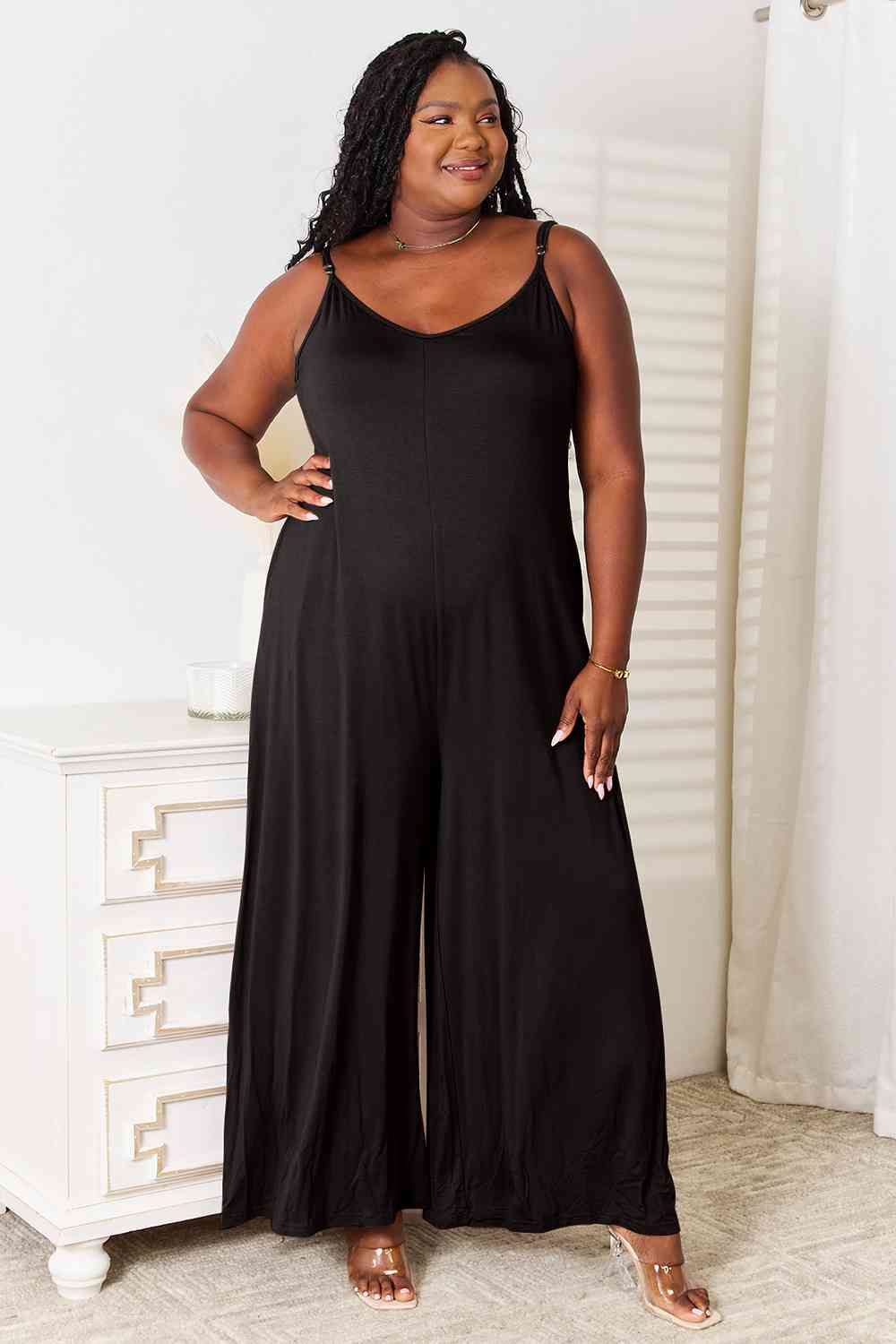 black, plus size, This spaghetti strap tied wide-leg jumpsuit is a modern and trendy choice for any occasion. Its wide-leg design and spaghetti straps create a flattering silhouette, while the tied detail adds a touch of elegance. This jumpsuit is chic and comfortable, perfect for a night out or a summer event