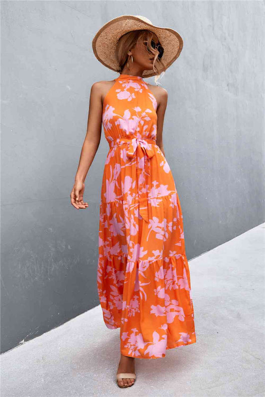 This Printed Sleeveless Tie Waist Maxi Dress is an ideal choice for both casual and formal occasions. Featuring a sleeveless design, the dress is perfect for wearing during the spring and summer months. However, it can also be layered for cooler weather in the fall and winter. Its flattering tie waist provides a stunning silhouette that you’ll love