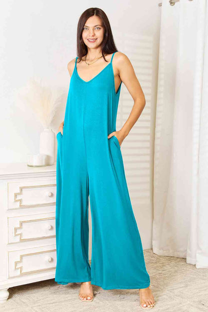 bl[ue, teal, turquiose, This spaghetti strap tied wide-leg jumpsuit is a modern and trendy choice for any occasion. Its wide-leg design and spaghetti straps create a flattering silhouette, while the tied detail adds a touch of elegance. This jumpsuit is chic and comfortable, perfect for a night out or a summer event