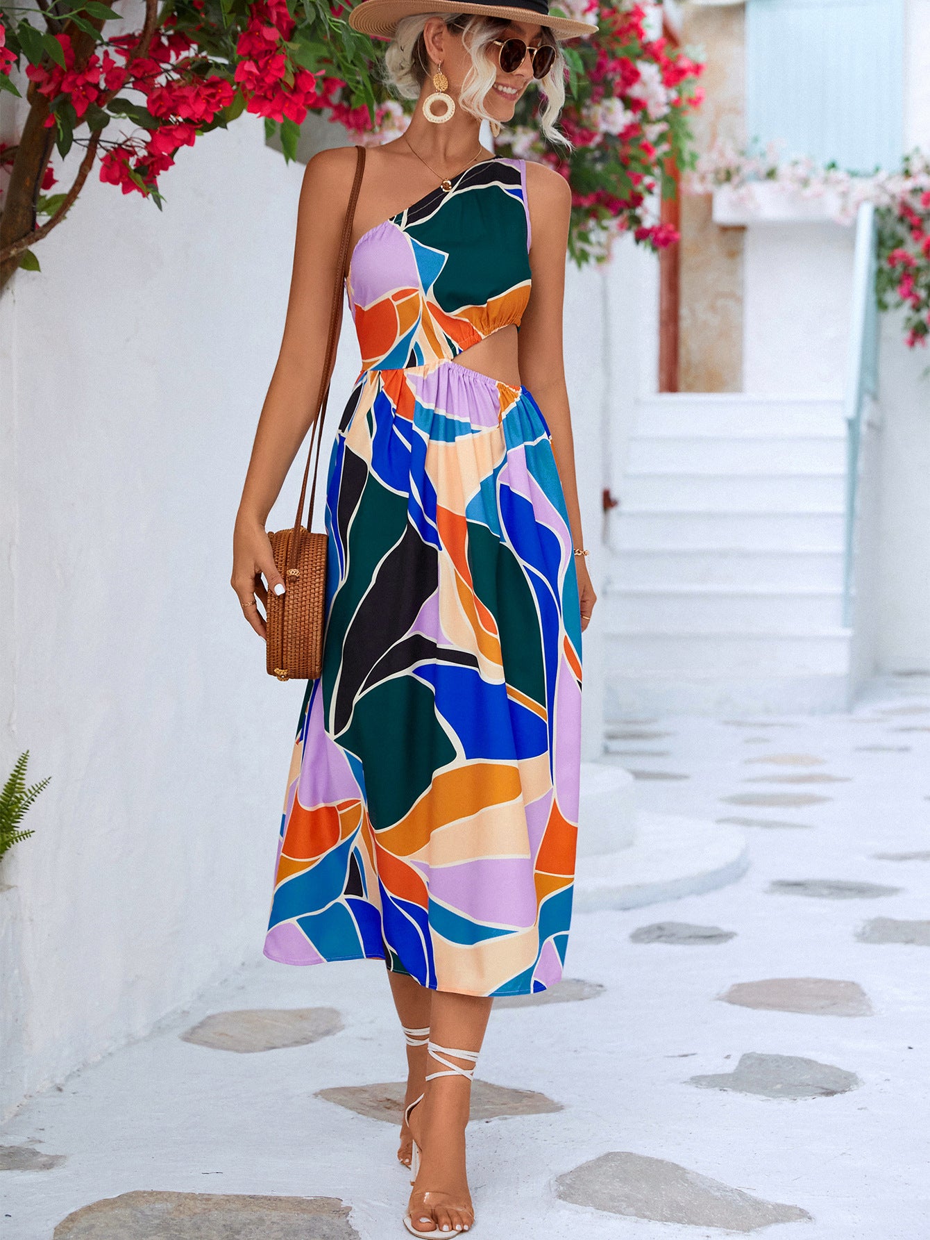 This one-shoulder sleeveless dress features a cutout design at the waist and a midi length. Pair with a floral headband or choker to accentuate your neckline.