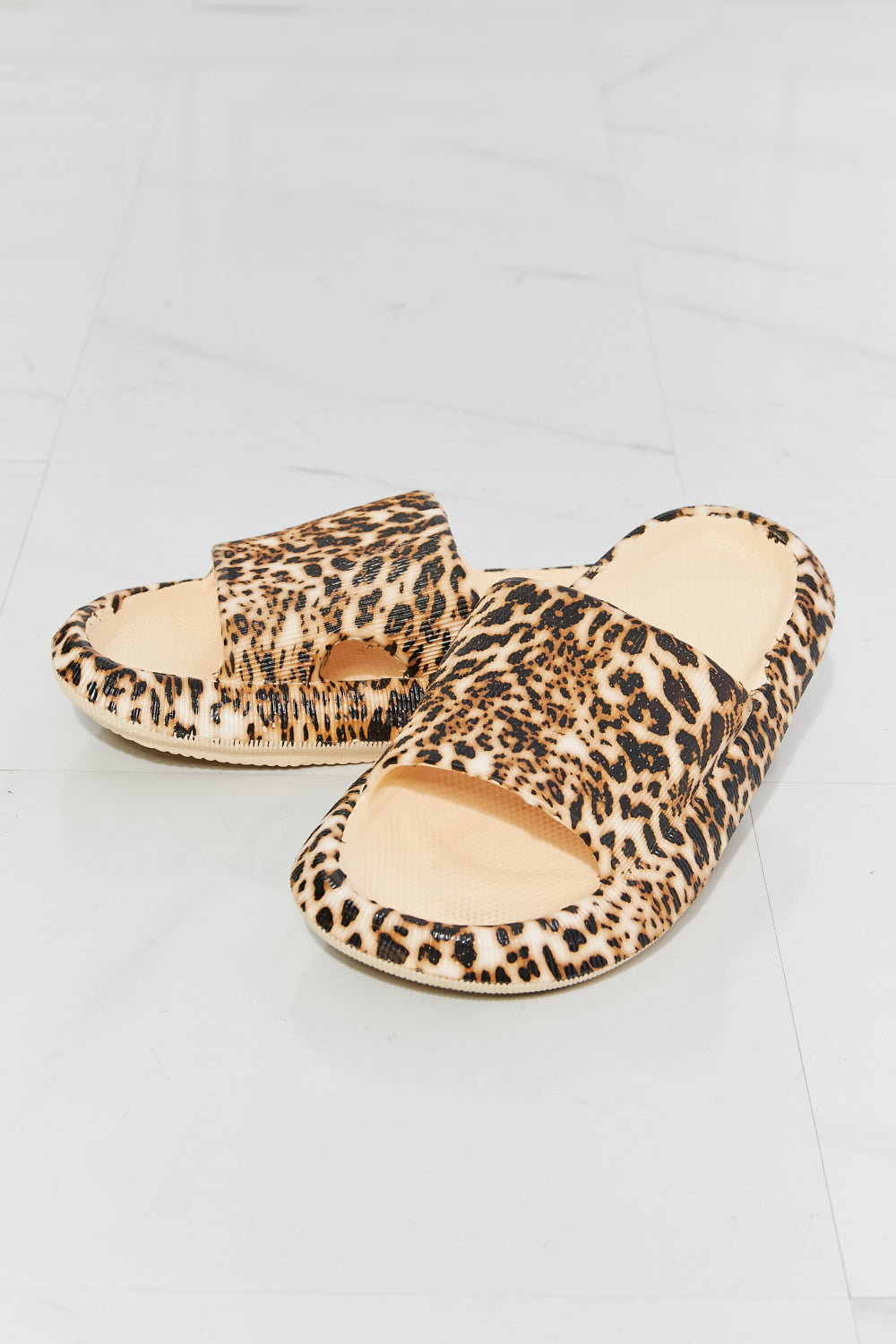 From the pool to the supermarket, these rubber slides are all comfort and all style. Their slide-on design makes them ideal for when you're running late, and their rubber composition makes them the perfect pool companion. Slide these on with a matching lounge set, cutoffs and a tee, or biker shorts and a crop cami.. Leopard print open toe sandal slides.
