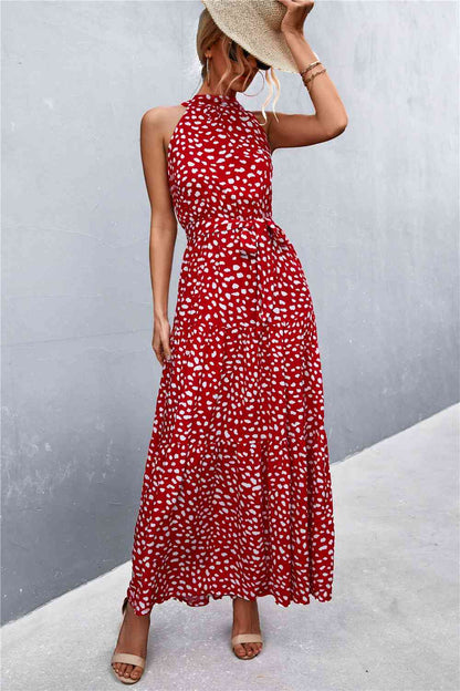 This Printed Sleeveless Tie Waist Maxi Dress is an ideal choice for both casual and formal occasions. Featuring a sleeveless design, the dress is perfect for wearing during the spring and summer months. However, it can also be layered for cooler weather in the fall and winter. Its flattering tie waist provides a stunning silhouette that you’ll love