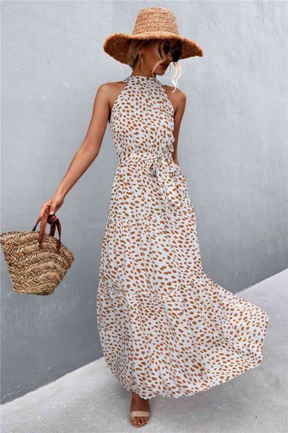 This Printed Sleeveless Tie Waist Maxi Dress is an ideal choice for both casual and formal occasions. Featuring a sleeveless design, the dress is perfect for wearing during the spring and summer months. However, it can also be layered for cooler weather in the fall and winter. Its flattering tie waist provides a stunning silhouette that you’ll love